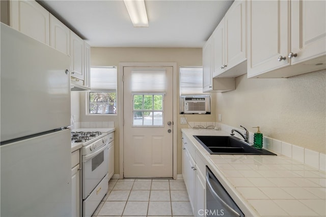 2707 S El Camino Real, San Clemente, CA 92672 - kitchen featuring white appliances, a sink, tile counters, under cabinet range hood, and white cabinets