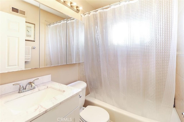 bathroom featuring toilet, shower / bath combo, and vanity