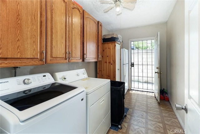 clothes washing area with cabinet space, washing machine and dryer, light flooring, and a ceiling fan