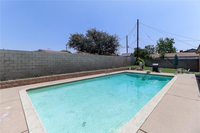 view of pool featuring a fenced backyard and area for grilling