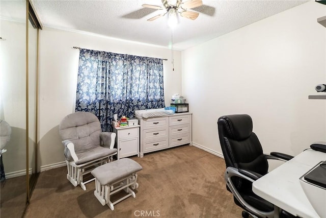 carpeted office with a ceiling fan, a textured ceiling, and baseboards