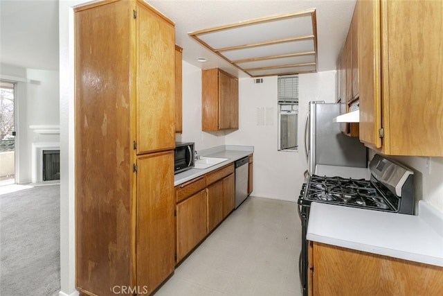 2807 W W Ave K12, Unit 256, Lancaster, CA 93536 - kitchen featuring appliances with stainless steel finishes, light countertops, and brown cabinets