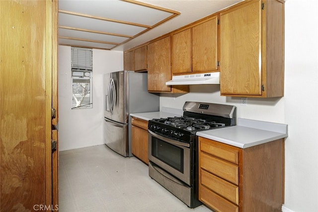 2807 W W Ave K12, Unit 256, Lancaster, CA 93536 - kitchen with stainless steel appliances, under cabinet range hood, light countertops, light flooring, and brown cabinets