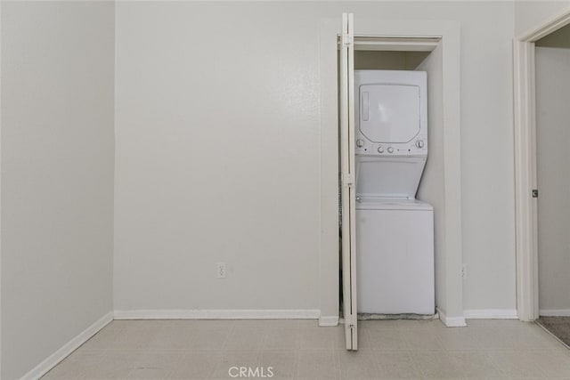 2807 W W Ave K12, Unit 256, Lancaster, CA 93536 - washroom featuring stacked washing machine and dryer and baseboards
