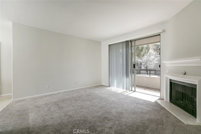 2807 W W Ave K12, Unit 256, Lancaster, CA 93536 - unfurnished living room with carpet floors, a fireplace with raised hearth, and baseboards