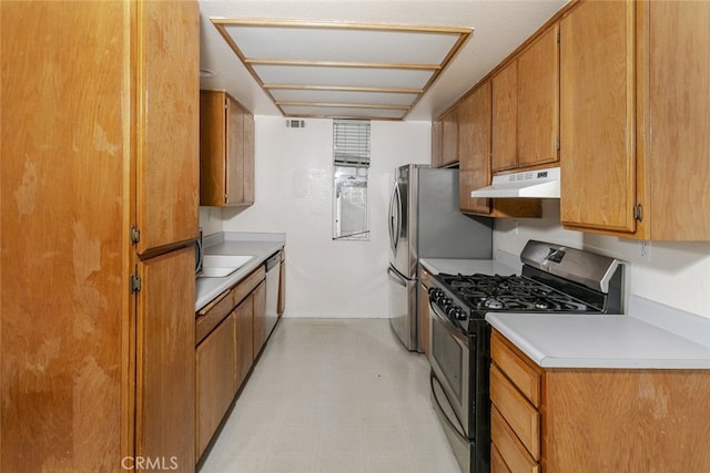 2807 W W Ave K12, Unit 256, Lancaster, CA 93536 - kitchen with stainless steel appliances, under cabinet range hood, brown cabinetry, and light countertops
