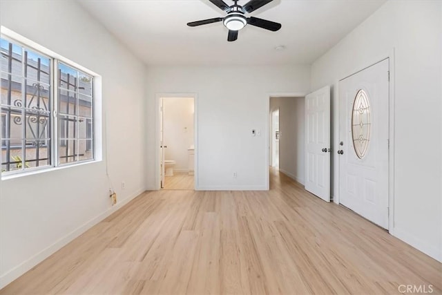 entrance foyer with light wood-type flooring, plenty of natural light, ceiling fan, and baseboards