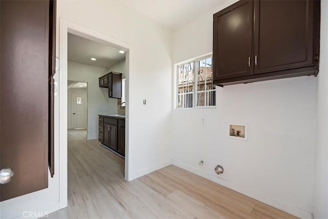 laundry area featuring cabinet space, washer hookup, gas dryer hookup, light wood-type flooring, and recessed lighting