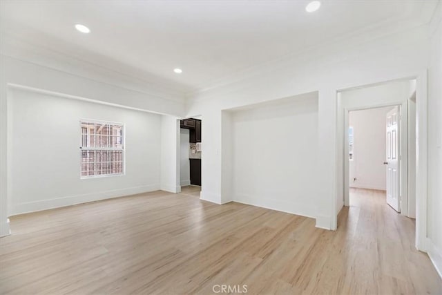 unfurnished living room featuring light wood finished floors, baseboards, and recessed lighting
