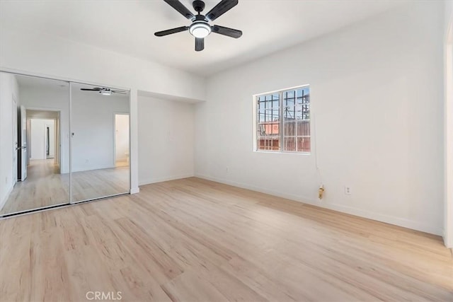 unfurnished bedroom with wood finished floors, baseboards, and ceiling fan