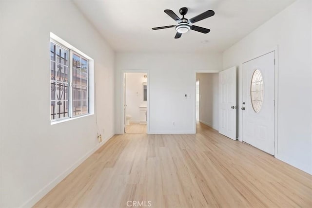 entryway featuring light wood finished floors, ceiling fan, and baseboards