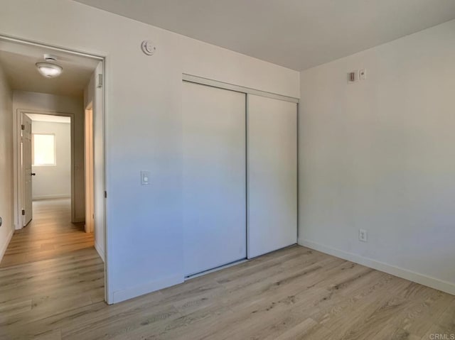 540 65th St Unit 203, San Diego, CA 92114 - unfurnished bedroom with light wood-style flooring, a closet, and baseboards