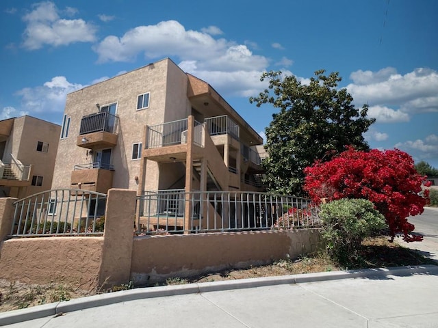 540 65th St Unit 203, San Diego, CA 92114 - rear view of property with fence and stucco siding