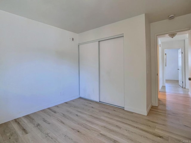 540 65th St Unit 203, San Diego, CA 92114 - unfurnished bedroom with light wood-type flooring, a closet, and baseboards
