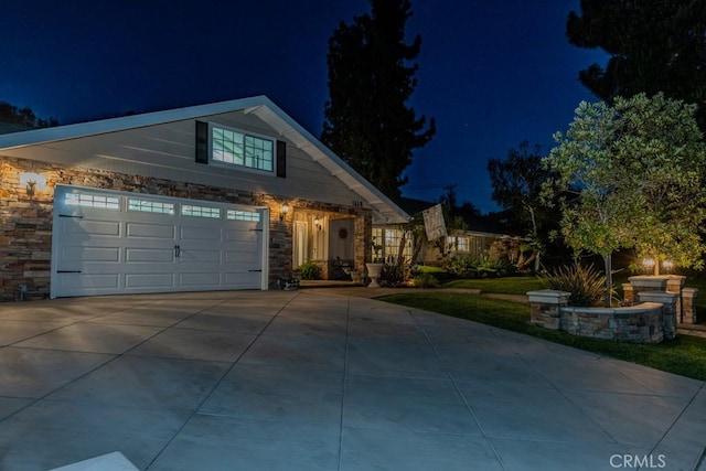 1448 W Domingo Rd, Fullerton, CA 92833 - view of front of home featuring stone siding, driveway, and a garage