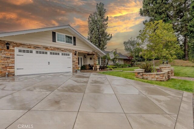 1448 W Domingo Rd, Fullerton, CA 92833 - view of front of home featuring concrete driveway, a garage, stone siding, and a yard