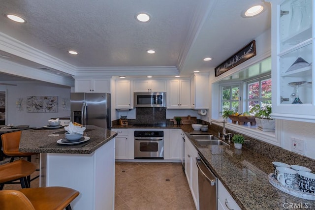 1448 W Domingo Rd, Fullerton, CA 92833 - kitchen featuring stainless steel appliances, a sink, crown molding, white cabinetry, and light tile patterned floors