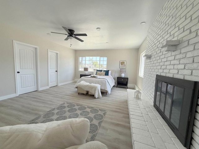 9944 Donner St, Santee, CA 92071 - bedroom with baseboards, light wood-style floors, a ceiling fan, and a brick fireplace