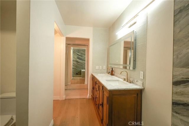 6670 Cozy Wood Ct, Whittier, CA 90601 - bathroom with toilet, wood finished floors, double vanity, and baseboards