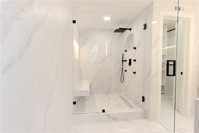 bathroom with a marble finish shower