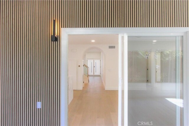 24701 Sarah Ln, Lake Forest, CA 92630 - hallway with arched walkways, light wood finished floors, and baseboards