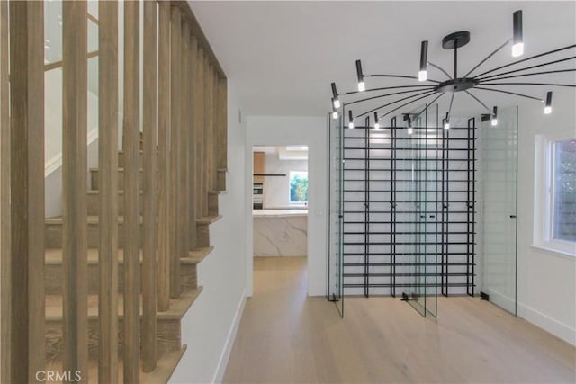 24701 Sarah Ln, Lake Forest, CA 92630 - staircase with wood finished floors, a chandelier, and baseboards