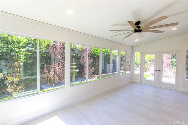 unfurnished sunroom with french doors, plenty of natural light, wood finished floors, vaulted ceiling, and recessed lighting