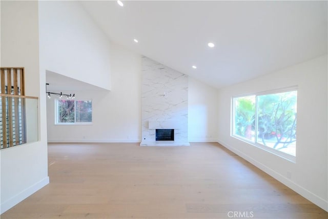 24701 Sarah Ln, Lake Forest, CA 92630 - unfurnished living room featuring healthy amount of natural light, light wood-style flooring, baseboards, recessed lighting, and a fireplace