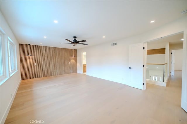 spare room featuring ceiling fan, light wood-type flooring, recessed lighting, and baseboards