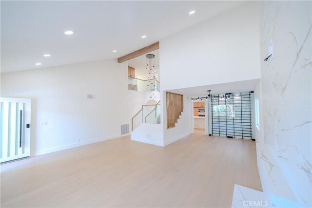 24701 Sarah Ln, Lake Forest, CA 92630 - unfurnished living room with wood finished floors, recessed lighting, high vaulted ceiling, baseboards, and a chandelier