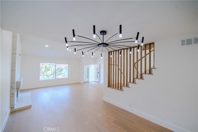 staircase with wood finished floors, a chandelier, baseboards, and recessed lighting