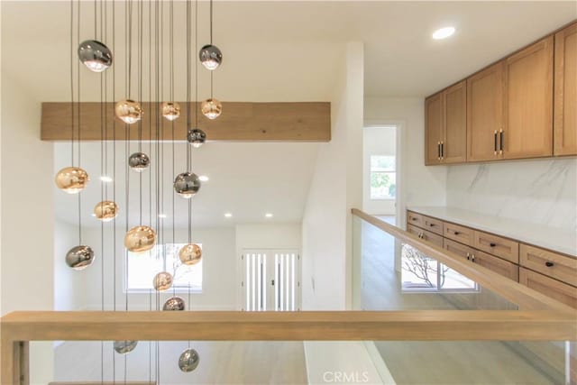 kitchen featuring brown cabinets, tasteful backsplash, recessed lighting, and light countertops