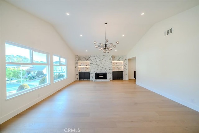 24701 Sarah Ln, Lake Forest, CA 92630 - unfurnished living room with light wood-style floors, a chandelier, a fireplace, baseboards, and high vaulted ceiling