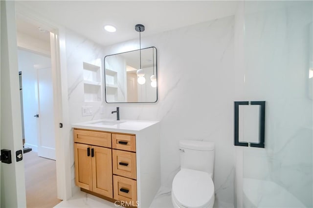 bathroom with toilet and vanity