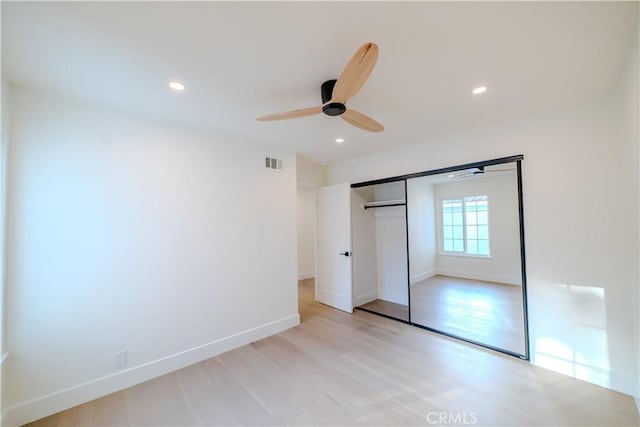 unfurnished bedroom featuring light wood-style flooring, recessed lighting, baseboards, a closet, and a ceiling fan