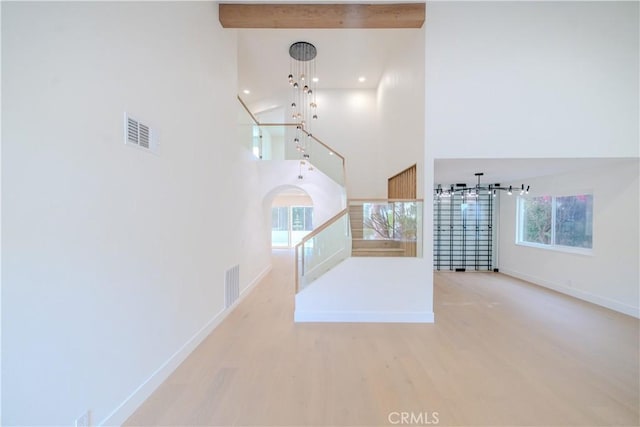 24701 Sarah Ln, Lake Forest, CA 92630 - unfurnished living room featuring a towering ceiling, wood finished floors, baseboards, healthy amount of natural light, and recessed lighting