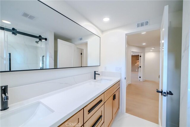 24701 Sarah Ln, Lake Forest, CA 92630 - bathroom featuring double vanity, a shower stall, and recessed lighting