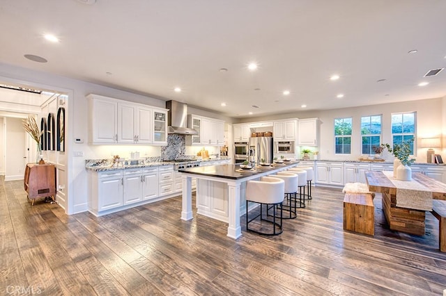 47 Cielo Azul, Mission Viejo, CA 92692 - kitchen featuring wall chimney exhaust hood, stainless steel appliances, white cabinetry, and recessed lighting