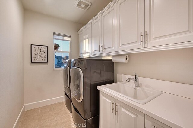 47 Cielo Azul, Mission Viejo, CA 92692 - laundry area featuring cabinet space, washing machine and clothes dryer, baseboards, and light tile patterned floors