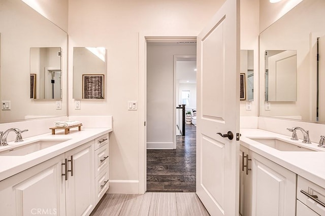 47 Cielo Azul, Mission Viejo, CA 92692 - bathroom with two vanities, baseboards, and wood finished floors