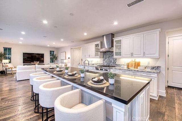 47 Cielo Azul, Mission Viejo, CA 92692 - kitchen featuring wall chimney range hood, a sink, white cabinets, dark wood finished floors, and recessed lighting