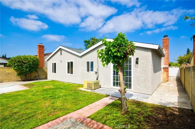 17721 Alexander Pl, Cerritos, CA 90703 - rear view of house featuring stucco siding, a patio area, and a chimney