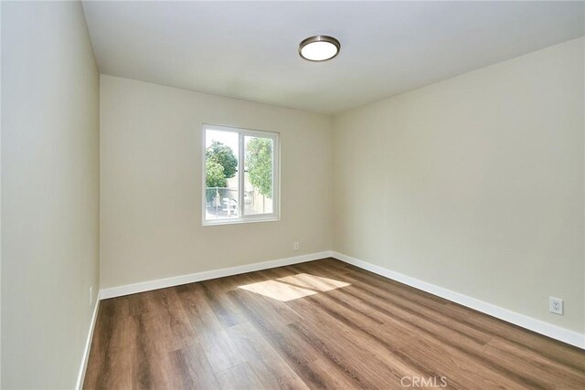 17721 Alexander Pl, Cerritos, CA 90703 - spare room featuring dark wood-style floors and baseboards