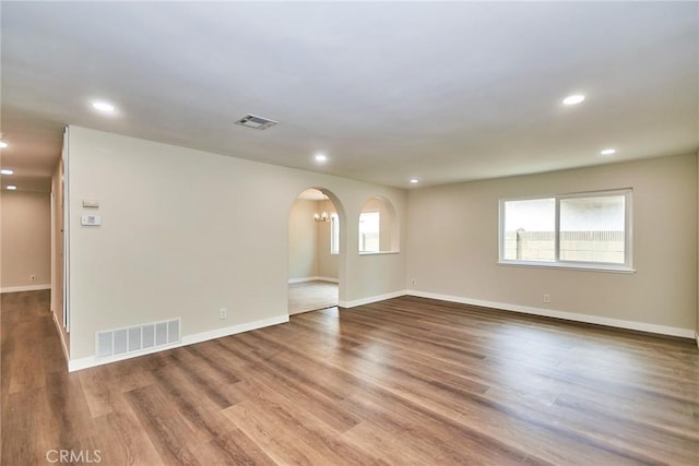 17721 Alexander Pl, Cerritos, CA 90703 - unfurnished room with arched walkways, wood finished floors, baseboards, and recessed lighting
