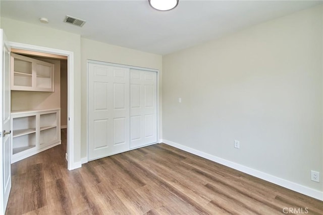 17721 Alexander Pl, Cerritos, CA 90703 - unfurnished bedroom featuring baseboards, wood finished floors, and a closet