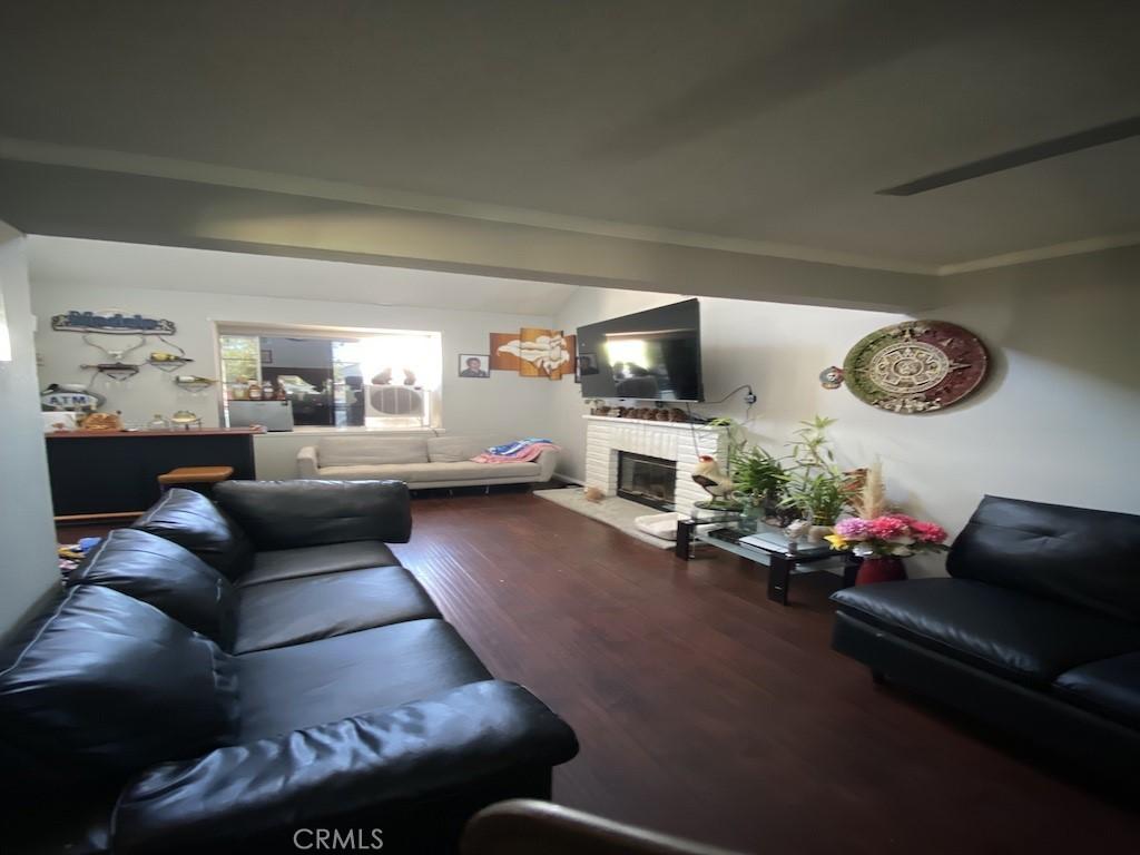 living area with wood finished floors and a fireplace