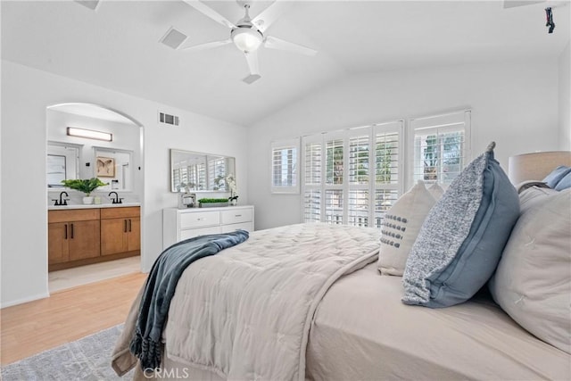 2 Chestnut Dr, Aliso Viejo, CA 92656 - bedroom with multiple windows, vaulted ceiling, light wood-type flooring, a sink, and arched walkways