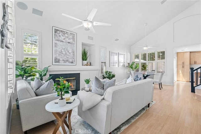 2 Chestnut Dr, Aliso Viejo, CA 92656 - living room featuring a ceiling fan, light wood-type flooring, high vaulted ceiling, and a tile fireplace