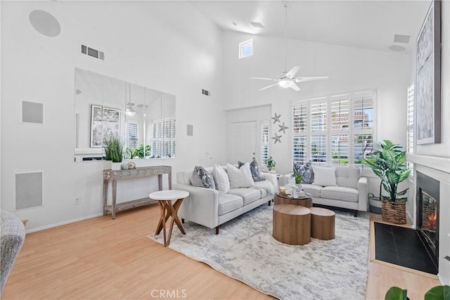 2 Chestnut Dr, Aliso Viejo, CA 92656 - living room with ceiling fan, wood finished floors, high vaulted ceiling, a fireplace with flush hearth, and baseboards
