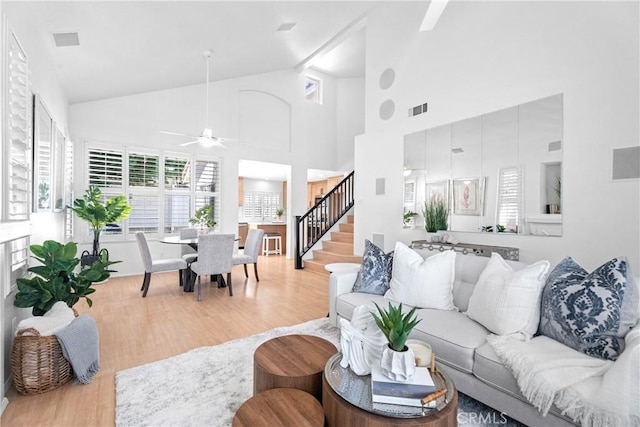 2 Chestnut Dr, Aliso Viejo, CA 92656 - living area featuring wood finished floors, ceiling fan, stairs, and high vaulted ceiling